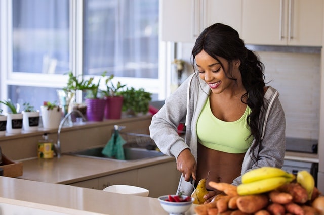 Young lady in kitchen preparing food